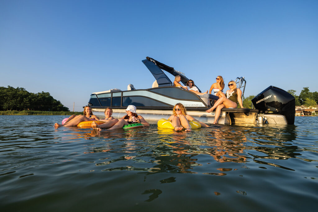group of friends making memories on the lake in a pontoon